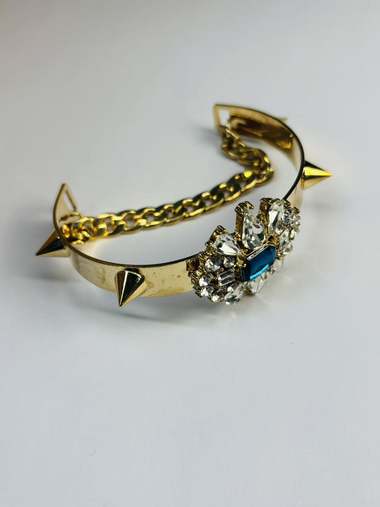 微信图片_20251112201235_231_64 Gold-Toned Spiked Cuff Bracelet with Blue and Clear Crystal Accents - Image 1